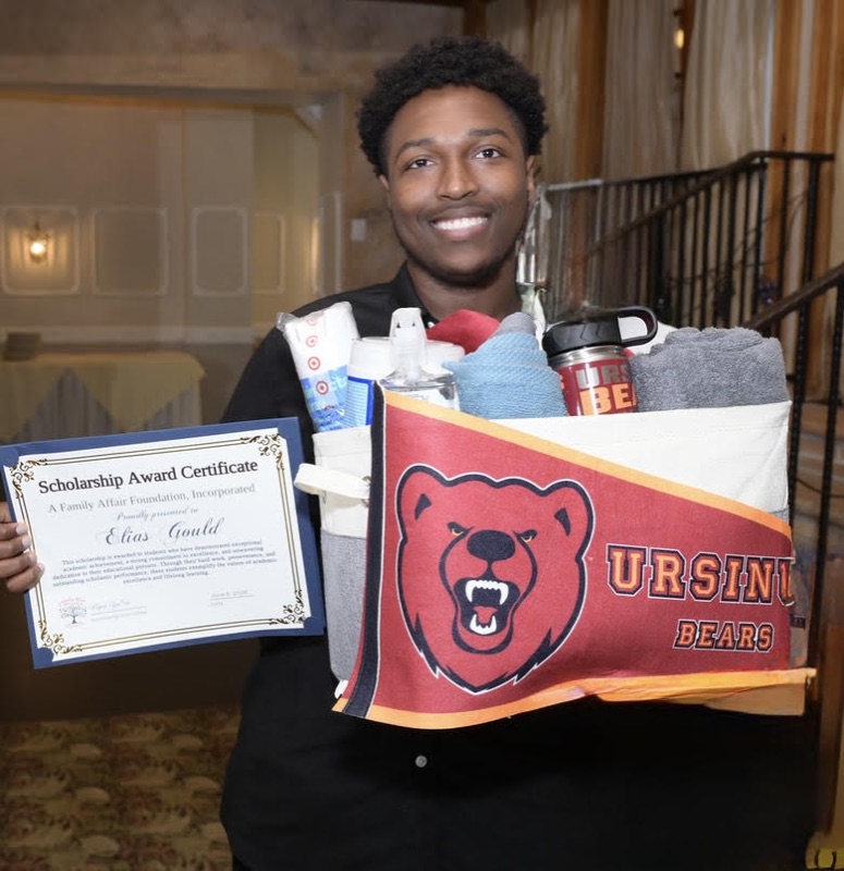 Elias Gould with his scholarship certificate and Ursinus College welcome basket